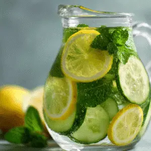 Refreshing Lemon Mint and Cucumber Water with lemon, cucumber, and mint leaves.