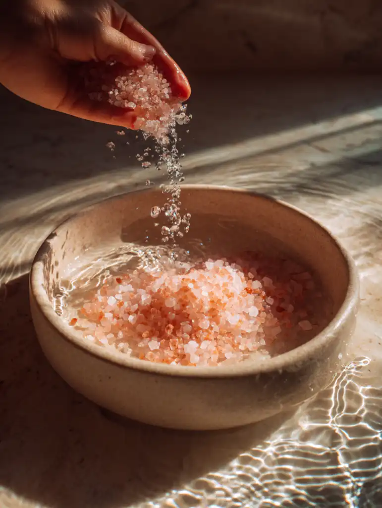 pink Himalayan salt recipe for neuropathy step pouring salt into warm water basin